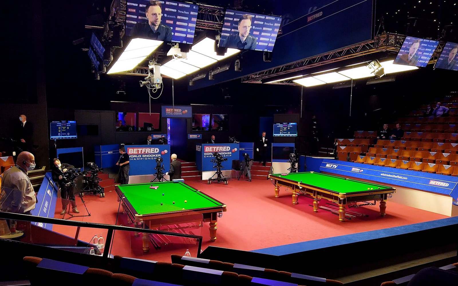 The Crucible Theatre's two match tables from above, dividing curtain between them, house lights up before a session
