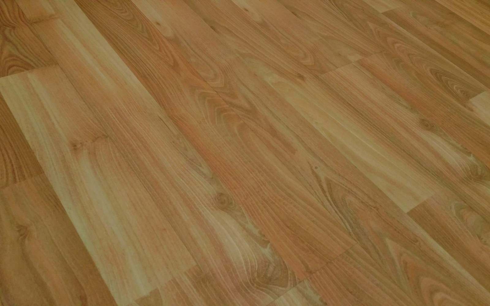 Close-up of laminate wood flooring planks with visible grain and knot patterns